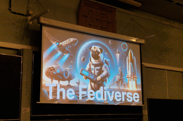 An image taken of John O'Nolan's presentation at FOSDEM. It shows an AI generated astronaut pug with the title The Fediverse. 