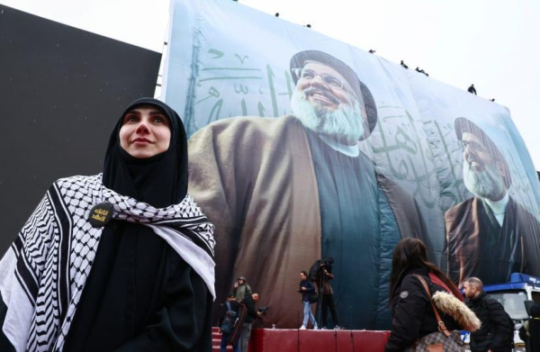 
Sahar Shehade stands near banners of former Hezbollah leaders Hassan Nasrallah and Hashem Safieddine, who were killed in Israeli airstrikes last year, during preparations for their funerals at Camille Chamoun Sports city stadium, in Beirut, Lebanon February 22, 2025
(photo credit: REUTERS/EMILIE MADI)
