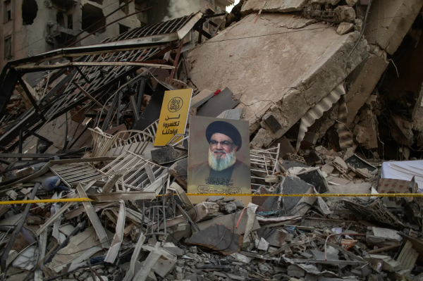 A picture of Hassan Nasrallah, the former Hezbollah leader, amid the rubble of a building destroyed by an Israeli airstrike in the Dahiya neighborhood, south of Beirut, in November.Credit...Diego Ibarra Sanchez for The New York Times