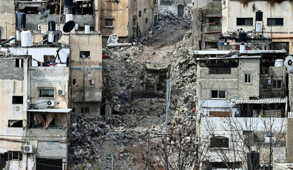 An Israeli bulldozer tears up a street during an ongoing raid in the Tulkarem camp for Palestinian refugees in the occupied West Bank on February 19, 2025. Since January 21, the Israeli military has been conducting a major operation in the "triangle" of Jenin, Tubas and Tulkarem, where half a million Palestinians live. (Photo by Zain JAAFAR / AFP)