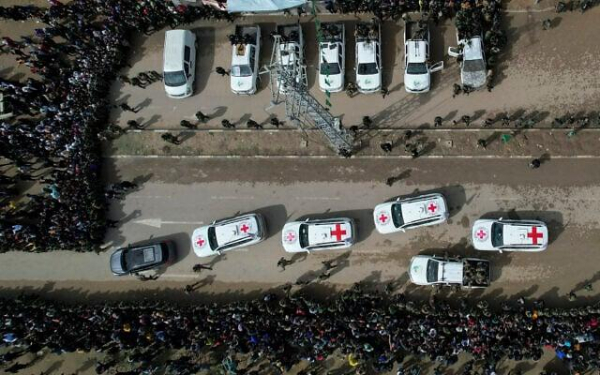 International Red Cross vehicles move carrying Israeli hostages, Eliya Cohen, Omer Shem and Omer Wenkert, after they were handed over by Hamas in Gaza Feb. 22, 2025. (AP/Mohammad Abu Samra)