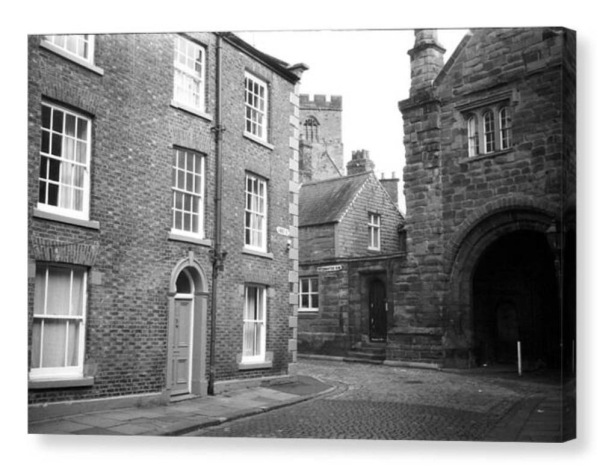 Black and white photo as a box canvas.  The print shows an old English street.  To the left Georgian buildings, to the right Elizabethan, and between them a cobbled road.