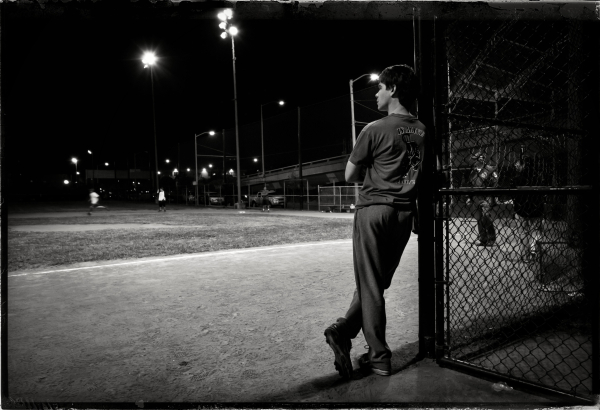 A baseball player leans against the backstop and gazes lazily as a runner head storage second base. Take at night, in 2011, under dark skies, in a field lit only by bright spotlights. 

This isn't heaven. It's San Francisco.