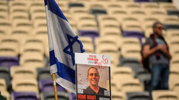 TEL AVIV, ISRAEL - FEBRUARY 28: Friends, relatives and members of the public react during a memorial ceremony for former Israeli hostage Tsachi Idan organized by the Hapoel Tel Aviv soccer team at Bloomfield Stadium on February 28, 2025 in Tel Aviv, Israel. The body of former Israeli hostage Tsachi Idan was returned to Israel from Gaza on Wednesday along with three other deceased hostages, as part of the ceasefire agreement between Israel and Hamas. Idan was 49 at the time of his abduction by Hamas militants on October 7, 2023, from his home in Kibbutz Nahal Oz. He is being buried alongside his teenage daughter, Maayan, who was shot and killed through the safe room door of their home during the attack.Â (Photo by Alexi J. Rosenfeld/Getty Images)