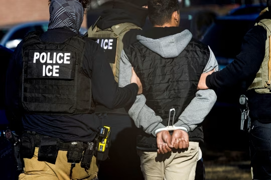 ICE officers arresting an undocumented immigrant: