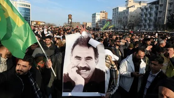 A demonstrator holds a picture of jailed Kurdish militant leader Abdullah Ocalan during a rally in Diyarbakir, Turkey, on February 27, 2025. (Reuters)