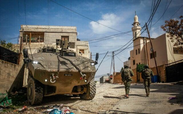 Israeli soldiers operate with their armored vehicles in the West Bank city of Jenin, March 4, 2025. (Nasser Ishtayeh/Flash90)