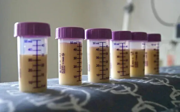 Illustrative: Bottles of expressed breast milk are seen on top of an incubator of a premature baby at Burnley General Hospital in Burnley, north-west England on May 15, 2020. (Hannah McKay / POOL / AFP)