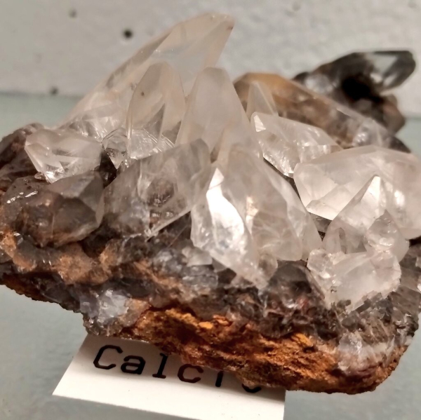 Bis clear calcite crystals in a Brown substrate