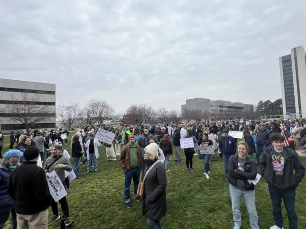 LArge crowd with lacards in a park in Raleigh