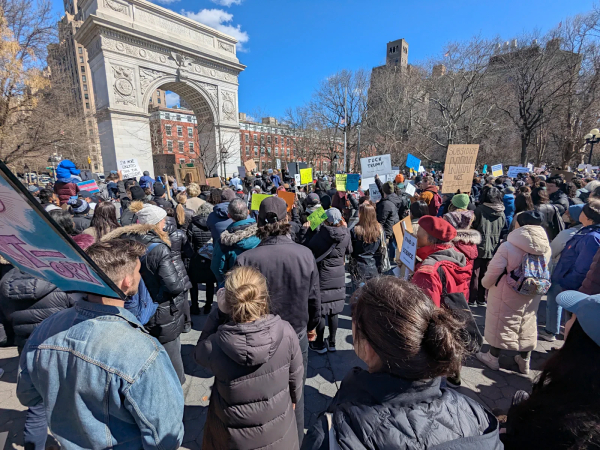 Crowd viewed from the middle. All faces are obscured. The podium was by the arch.