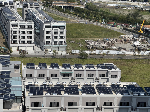 Several banks of row houses, all with solar arrays on top.