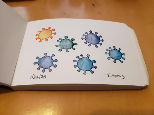 Hand drawn generative/procedural art in ink on an open page of my sketchbook. The abstract patterns looks like virus particles of different colors. The orange one looks menacing, but is just another virus.