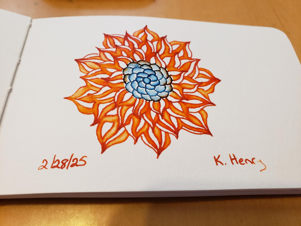 Hand drawn generative/procedural art in ink on an open page of my sketchbook. The abstract pattern is floral and is blue and orange, in respect and support for Ukraine.