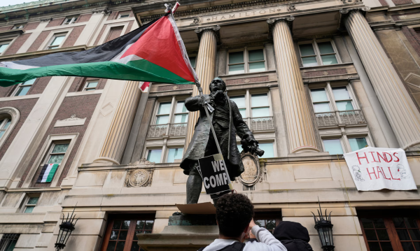 A student protester parades a Palestinian flag at Columbia University in New York City, on 30 April 2024. Photograph: Mary Altaffer/AP
