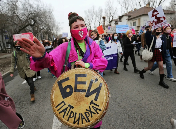 Women with drums and placards march in Almaty, Kazhakstan