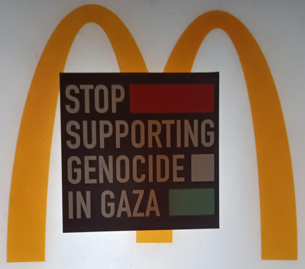 A sticker with the text 'STOP SUPPORTING GENOCIDE IN GAZA' pasted on a Mc Donalds logo. Probably from some advertisement.