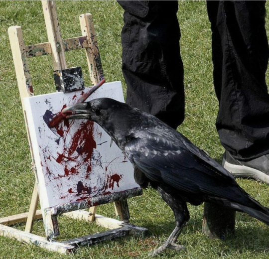 large raven standing in front of ann easel with a paintbrush in its beak, painting on a canvas in blood-colored paint